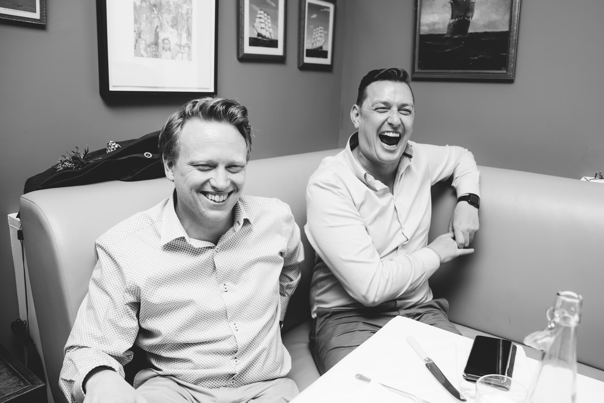 Gay couple laughing during speeches